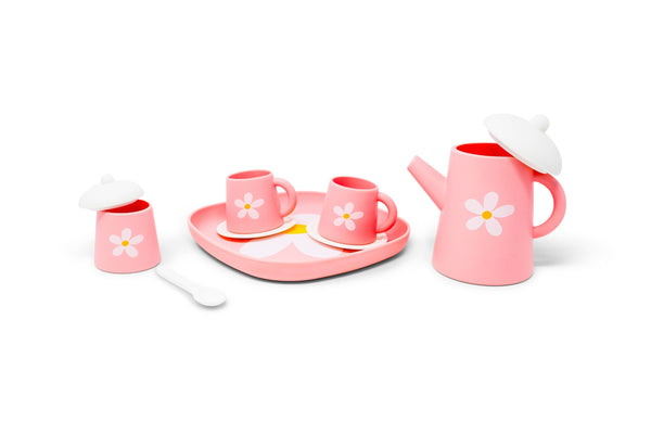 Pink children's tea set with matching accessories on a white background