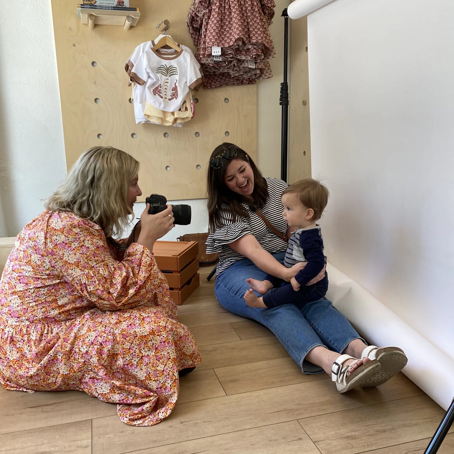 Photographer taking photos of mom and toddler son at a Broomtail photo session event
